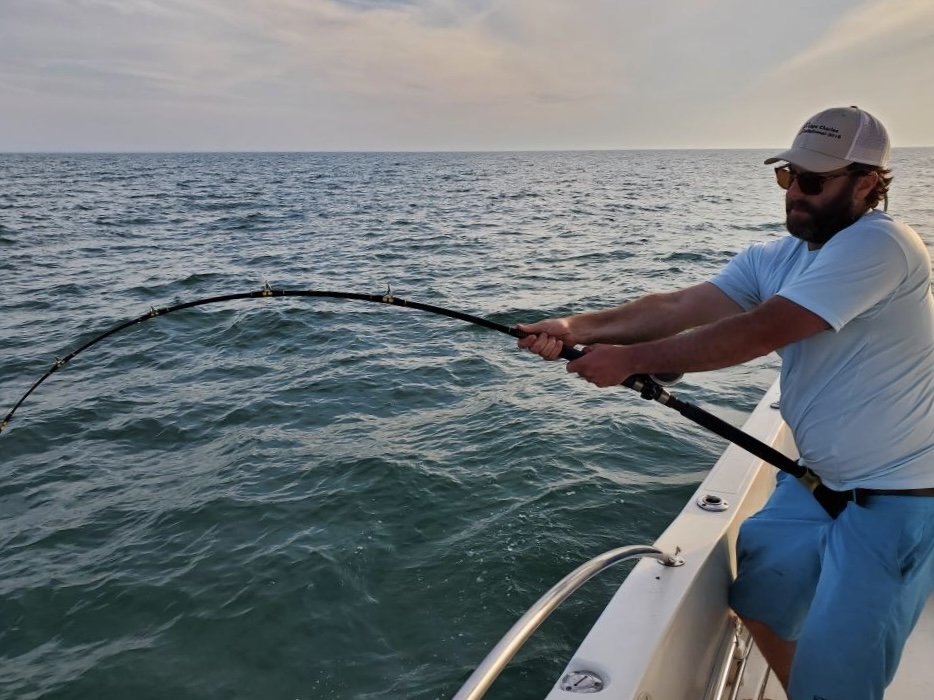 Angler fighting a fish offshore